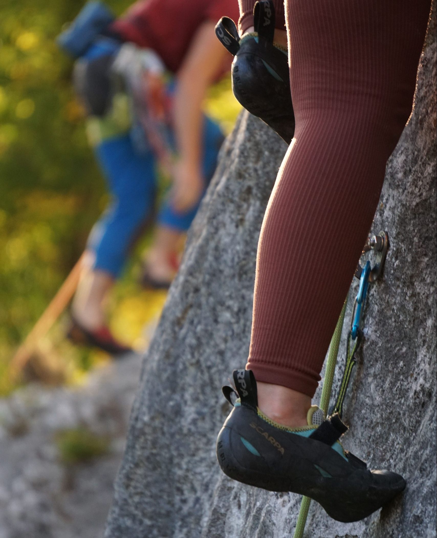 Climbing shoes stepping on rock